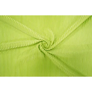 Detail view of lime green pleated fabric for plus size women's fashion apparel.