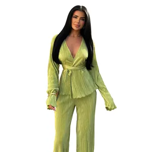 Full view of elegant lime green pleated two-piece set with long-sleeved wrap top