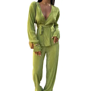 Detailed view of a lime green pleated wrap top and wide-leg trousers two-piece set.