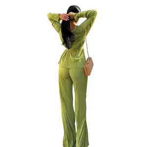 Back view of women's plus size green pleated long sleeve casual top and matching pants