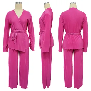 Detailed view of pink pleated long sleeve two-piece set with wrap belt and pants