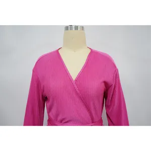 Close-up detail of hot pink pleated wrap V-neck long sleeve casual top for women