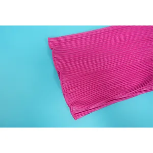 Detailed macro view of vibrant pink pleated fabric texture on a long sleeve hem