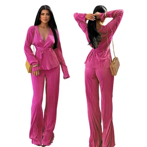 Elegant magenta pleated two-piece set featuring V-neck top and wide-leg trousers.