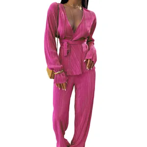 Detailed full view of an elegant fuchsia pleated casual set with wrap top and wide-leg trousers