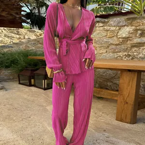 Elegant magenta plissé pleated two-piece set with long sleeve wrap top and wide-leg trousers