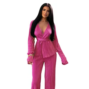 Detailed view of stylish women's hot pink pleated two-piece set with long sleeve top