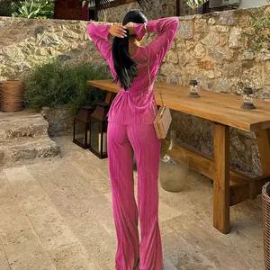 Detailed rear view of vibrant magenta pleated long-sleeve top and wide-leg trousers set