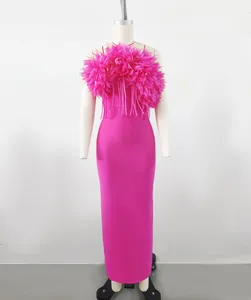 Elegant hot pink bandage maxi dress with ruffled floral chest detail on mannequin display