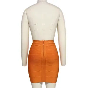 Back view detail of bright orange bandage bodycon mini skirt featuring a metal zipper closure