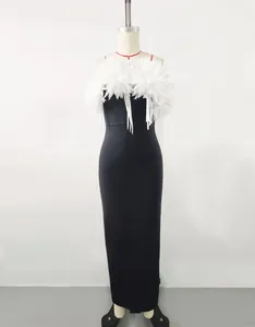 Detail of elegant black bandage dress with large white flower feather bust decoration