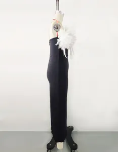 Detailed side view of black bandage maxi dress featuring a large white flower decoration