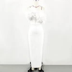 Detailed macro shot of white bandage maxi dress featuring 3D floral embellishments