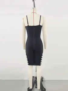 Detailed back view of a sexy black bandage bodycon dress featuring white side cut-outs