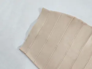 Macro view of high-quality beige bandage fabric texture on a women's bodycon skirt