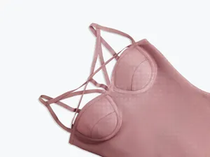 Close-up of a pink bodycon bandage dress featuring cross-strap details and molded cups
