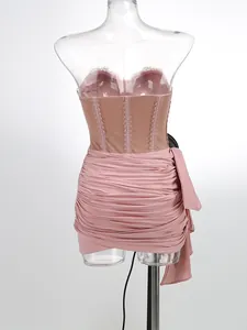 Back view of a pink ruched mesh corset mini dress on a transparent mannequin for party.