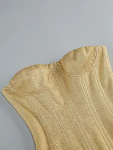 Detailed view of the gold shimmering sequined fabric on a strapless corset tube top