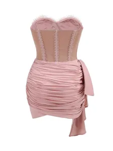 Close-up detail of sexy pink ruched corset dress with lace trim and asymmetrical hemline
