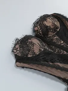 Detailed macro shot of the intricate black floral lace and sheer mesh on a sexy dress