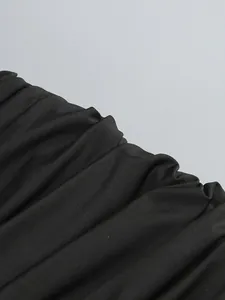 Close-up showing the intricate ruched fabric texture of this elegant black bodycon dress