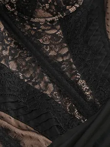 Close-up of delicate black lace and sheer mesh detail on a sexy tube top dress.