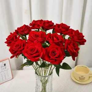 Detailed macro view of velvet artificial red roses in a glass vase for home decoration