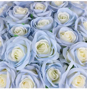 Detailed macro view of artificial velvet roses featuring soft light blue and cream white petals