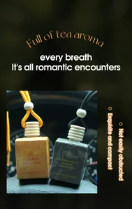 Detail view of two FORMBO car air freshener pendants in citrus and tea scents.