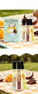 Close-up of three rollerball perfumes with ice cream scents in a picnic setting