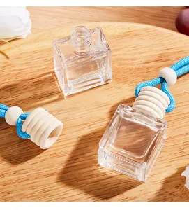 Detail shot of empty glass car perfume diffuser bottle with wooden cap and blue cord