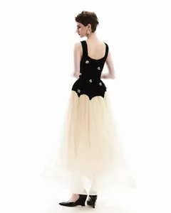 Back view of elegant sleeveless dress with 3D gold floral appliques and tulle skirt