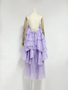 Detailed back view of an elegant purple ruffled maxi dress with delicate cross strap design