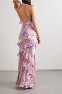 Back view of elegant floral ruffled maxi dress with backless design and spaghetti straps