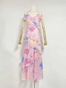 Detailed view of an elegant pink floral vacation dress with ruffled tiers and a V-neckline