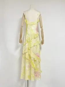 Back view of yellow floral maxi dress featuring elegant ruffle layers and thin straps