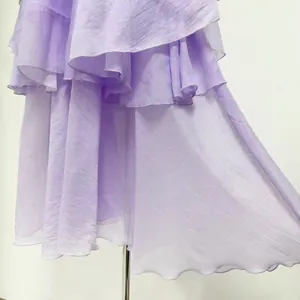 Detail view showing the lavender tiered ruffles and pleated textures of an elegant dress