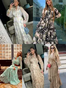 Detailed view of tiered floral maxi dresses with lantern sleeves and belted waist.