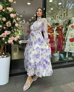 Elegant purple floral tiered maxi dress with lantern sleeves and waist tie detail.