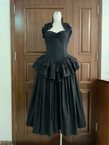 Detailed view of black halter cake dress with corset boning and pleated large swing skirt