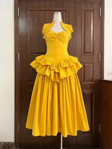 Detail showing yellow layered ruffle cake dress with structured fishbone corset bodice