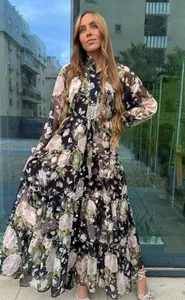 Elegant long floral maxi dress featuring lantern sleeves and tiered skirt details