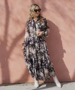 Elegant floral print tiered maxi dress featuring V-neck and lantern sleeves outdoors