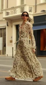 Elegant floral V-neck tiered maxi dress with lantern sleeves and waist tie in a street setting