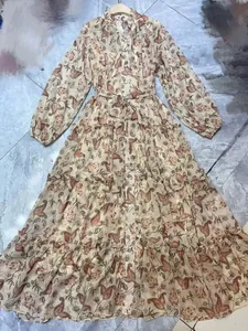 Detailed view of a floral paisley maxi dress with tiered ruffles and V-neckline.