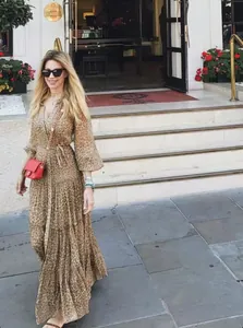 Full-length street style view of a leopard print V-neck maxi dress with lantern sleeves