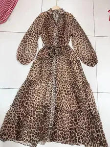 Leopard print maxi dress with V-neck, lantern sleeves, and tiered skirt detail view