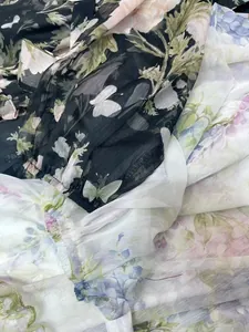 Close-up of floral chiffon fabric showing elastic lantern sleeve cuffs in two colors.