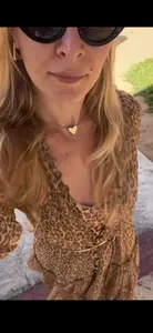 Detailed view of a stylish leopard print V-neck dress featuring layered ruffles and waist tie
