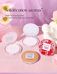 Close-up of portable solid perfume balms with cherry and star scents in elegant pink decor